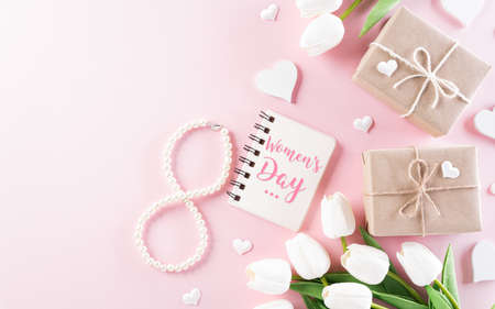 Pink hearts with gift box and tulip on pastel paper background. Womens day, Love and Valentine's day concept.の写真素材