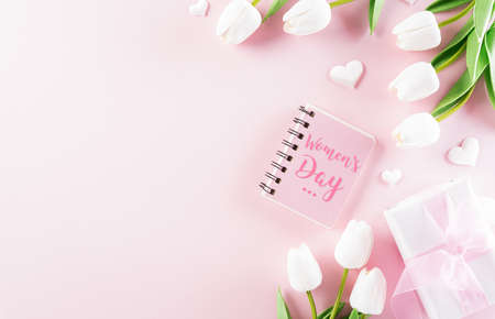 Pink hearts with gift box and tulip on pastel paper background. Womens day, Love and Valentine's day concept.の写真素材