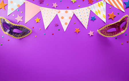 Happy Purim carnival decoration concept made from mask and sparkle star on purple background. (Happy Purim in Hebrew, jewish holiday celebrate)の写真素材