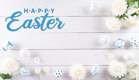 Happy easter! Colourful of Easter eggs in with flower on white wooden background. Greetings and presents for Easter Day celebrate time.の写真素材