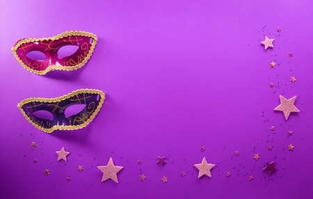 Happy Purim carnival decoration concept made from mask and sparkle star on purple background. (Happy Purim in Hebrew, jewish holiday celebrate)の写真素材