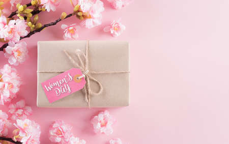 Happy women's day concept made from pink plum blossom and gift box on pastel background. Flat lay ,top view.の写真素材