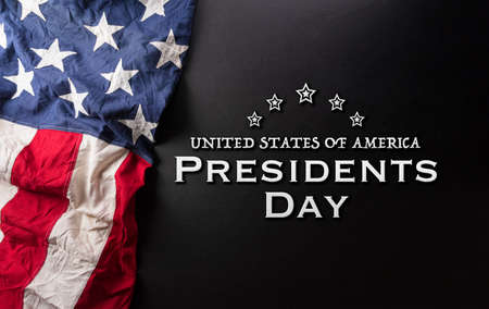 Happy presidents day concept with flag of the United States and the text on dark  background.の写真素材