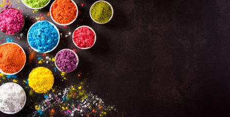 Happy holi festival decoration.Top view of colorful holi powder on dark background with copy space for text.の写真素材