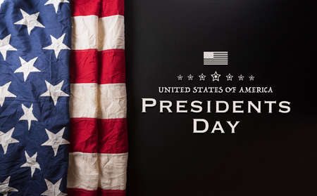 Happy presidents day concept with flag of the United States and the text on dark  background.の写真素材