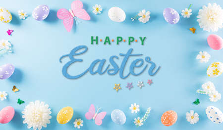 Happy easter! Colourful of Easter eggs in with flower on pastel blue background. Greetings and presents for Easter Day celebrate time. Flat lay ,top view with the text.の写真素材