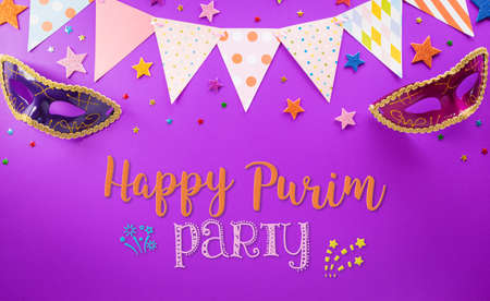 Happy Purim carnival decoration concept made from mask and sparkle star on purple background. (Happy Purim in Hebrew, jewish holiday celebrate)の写真素材