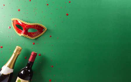 Happy Purim carnival decoration concept made from red mask, wine, and sparkle star on green background. (Happy Purim in Hebrew, jewish holiday celebrate).の写真素材