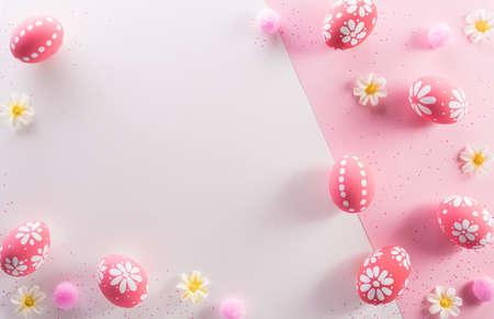 Happy easter decoration concept. Colourful Easter eggs with flowers on pink and white background.の写真素材
