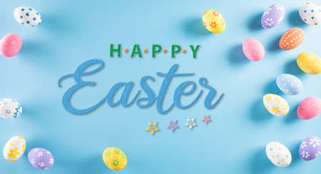 Happy easter! Colourful of Easter eggs on pastel blue background. Greetings and presents for Easter Day celebrate time.の写真素材