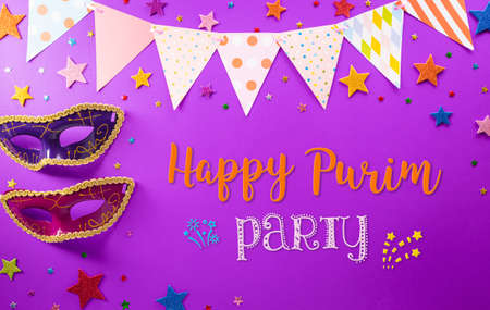 Happy Purim carnival decoration concept made from mask and sparkle star on purple background. (Happy Purim in Hebrew, jewish holiday celebrate)の写真素材