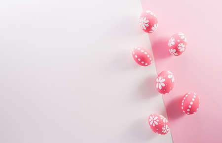 Happy easter decoration concept. Colourful Easter eggs on pink and white background.の写真素材