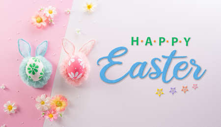 Happy easter decoration concept. Colourful Easter eggs with flowers and the text on pink and white background.の写真素材