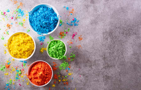 Happy Holi decoration, the indian festival.Top view of colorful holi powder on dark stone background.の写真素材