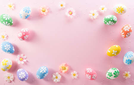 Happy easter decoration concept. Colourful Easter eggs with flowers on pink pastel background.の写真素材