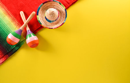 Cinco de Mayo holiday background made from maracas, mexican blanket stripes or poncho serape and hat on yellow background.の写真素材