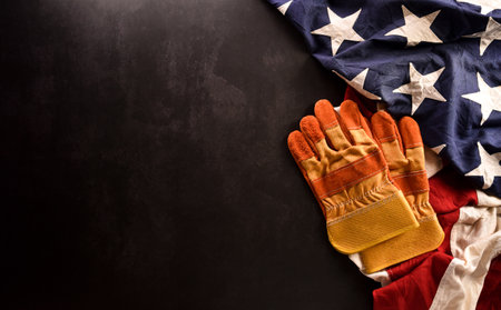 Happy Labor day concept. American flag with different construction tools on dark stone background.の写真素材