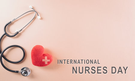 Top view of doctor stethoscope and red heart on pastel background. International nurse day and medical concept.の写真素材