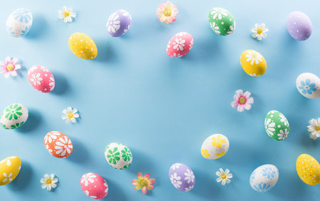Happy easter! colourful Easter eggs with flower on pastel blue background.の写真素材