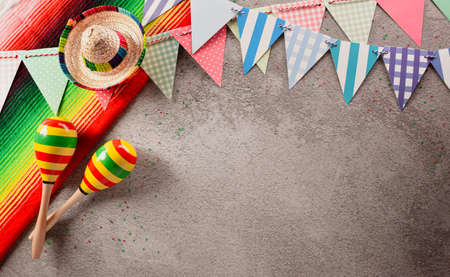 Cinco de Mayo holiday background made from maracas and hat on dark stone background.の写真素材