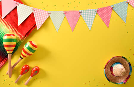 Cinco de Mayo holiday background made from maracas and hat on yellow background.の写真素材