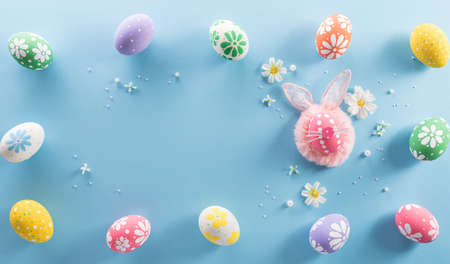 Happy easter! colourful Easter eggs with flower on pastel blue background.の写真素材