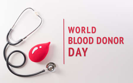 World blood donor day, red cross and nurse day concept made from red blood drop and stethoscope with the text on white background.の写真素材