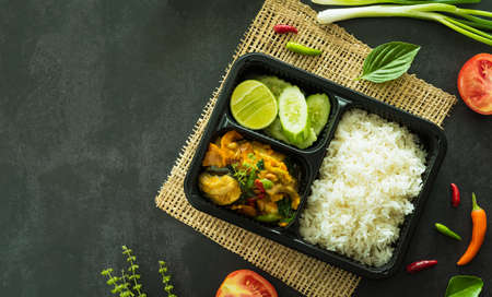 Top view of stir fried basil with fish, a famous Thai food served in box for delivery food concept.の写真素材