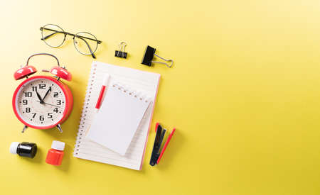 Education or back to school Concept. Top view of Colorful school supplies with books, color pencils, calculator, pen cutter clips and apple on pastel paper background.の写真素材