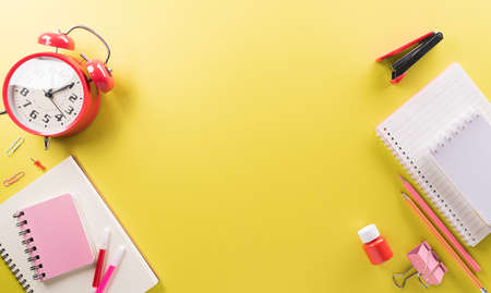 Education or back to school Concept. Top view of Colorful school supplies with books, color pencils, calculator, pen cutter clips and apple on pastel paper background.の写真素材
