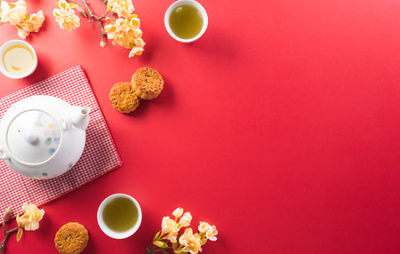 Chinese Mid-Autumn Festival concept made from mooncakes, tea and plum blossom. Chinese characters FU in the article refer to fortune good luck, wealth, money flow.の写真素材