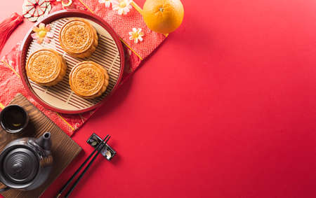 Chinese Mid-Autumn Festival concept made from mooncakes, tea and plum blossom. Chinese characters FU in the article refer to fortune good luck, wealth, money flow.の写真素材