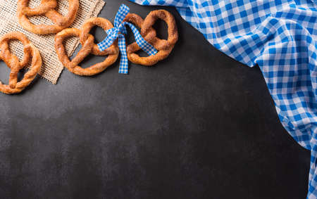 Oktoberfest festival decoration symbols made from Pretzel loaf and Bavarian white and blue fabric on...