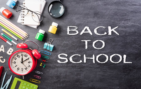 Education or back to school Concept. Top view of Colorful school supplies with books, color pencils, calculator, pen, cutter and clips on backboard background.の写真素材