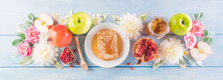 Rosh hashanah (jewish New Year holiday), Concept of traditional or religion symbols on pastel blue wooden background.の写真素材