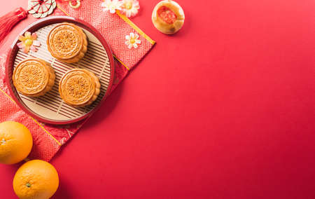 Chinese Mid-Autumn Festival concept made from mooncakes, tea and plum blossom. Chinese characters FU in the article refer to fortune good luck, wealth, money flow.の写真素材