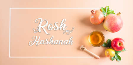 Rosh hashanah (Jewish New Year holiday), Concept of traditional or religion symbols on pastel orange paper background.の写真素材