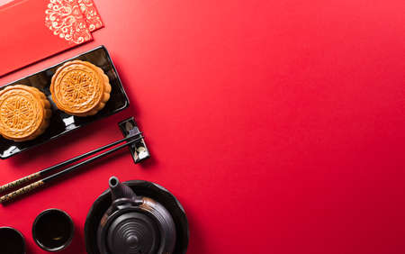Chinese Mid-Autumn Festival concept made from mooncakes, tea and plum blossom. Chinese characters FU in the article refer to fortune good luck, wealth, money flow.の写真素材