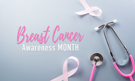 Pink ribbon and stethoscope on pastel paper background for supporting breast cancer awareness month campaign.の写真素材