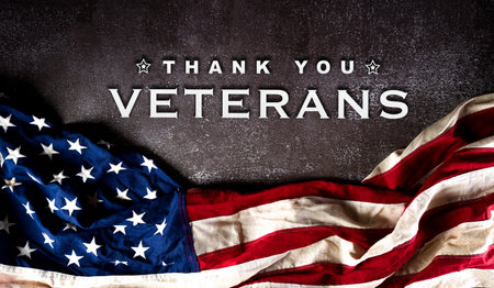 Happy Veterans Day concept. American flags against a dark stone  background. November 11.の写真素材
