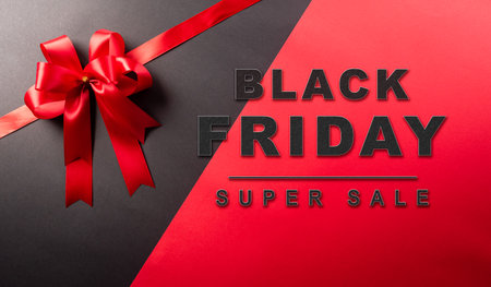 Top view of red ribbon decoration on black and red background. Shopping concept boxing day and Black Friday composition.の写真素材