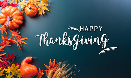 Autumn and thanksgiving decoration concept made from autumn leaves and pumpkin on dark background. Flat lay, top view with copy space.の写真素材