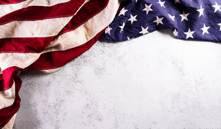 Happy Veterans Day concept. American flags against a white stone  background. November 11.の写真素材