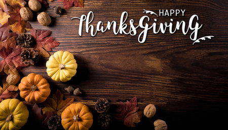 Thanksgiving and Autumn decoration composition. Pumpkin, pine cone, autumn leaves and the text on dark wooden background.の写真素材