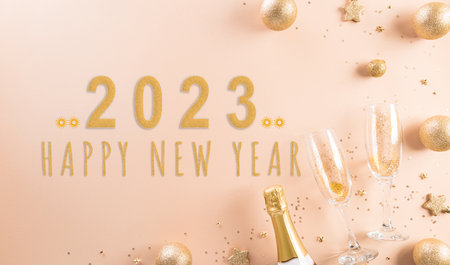 Happy New year celebration background concept. Golden christmas ball, star and champagne glasses on pastel background.の写真素材