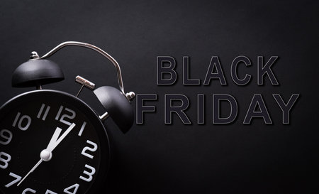Top view of Black Friday background concept made from  alarm clock and the text on black background. Shopping concept boxing day and Black Friday composition.の写真素材