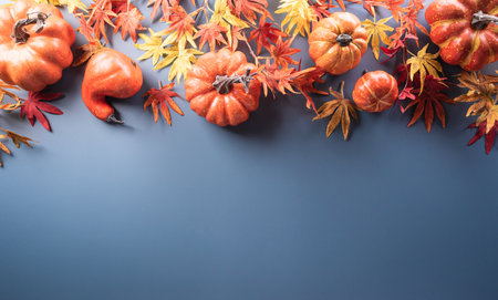 Autumn and thanksgiving decoration concept made from autumn leaves, berry and pumpkin on pastel...