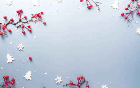 Christmas and new year background concept. Top view of Christmas star, red berry and snowflake on pastel blue background.の写真素材