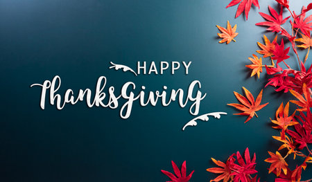 Thanksgiving and autumn decoration concept made from autumn leaves and the text on dark background.