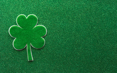 Happy St Patrick's Day decoration concept made from shamrocks ( clover leaf) on green background.の写真素材